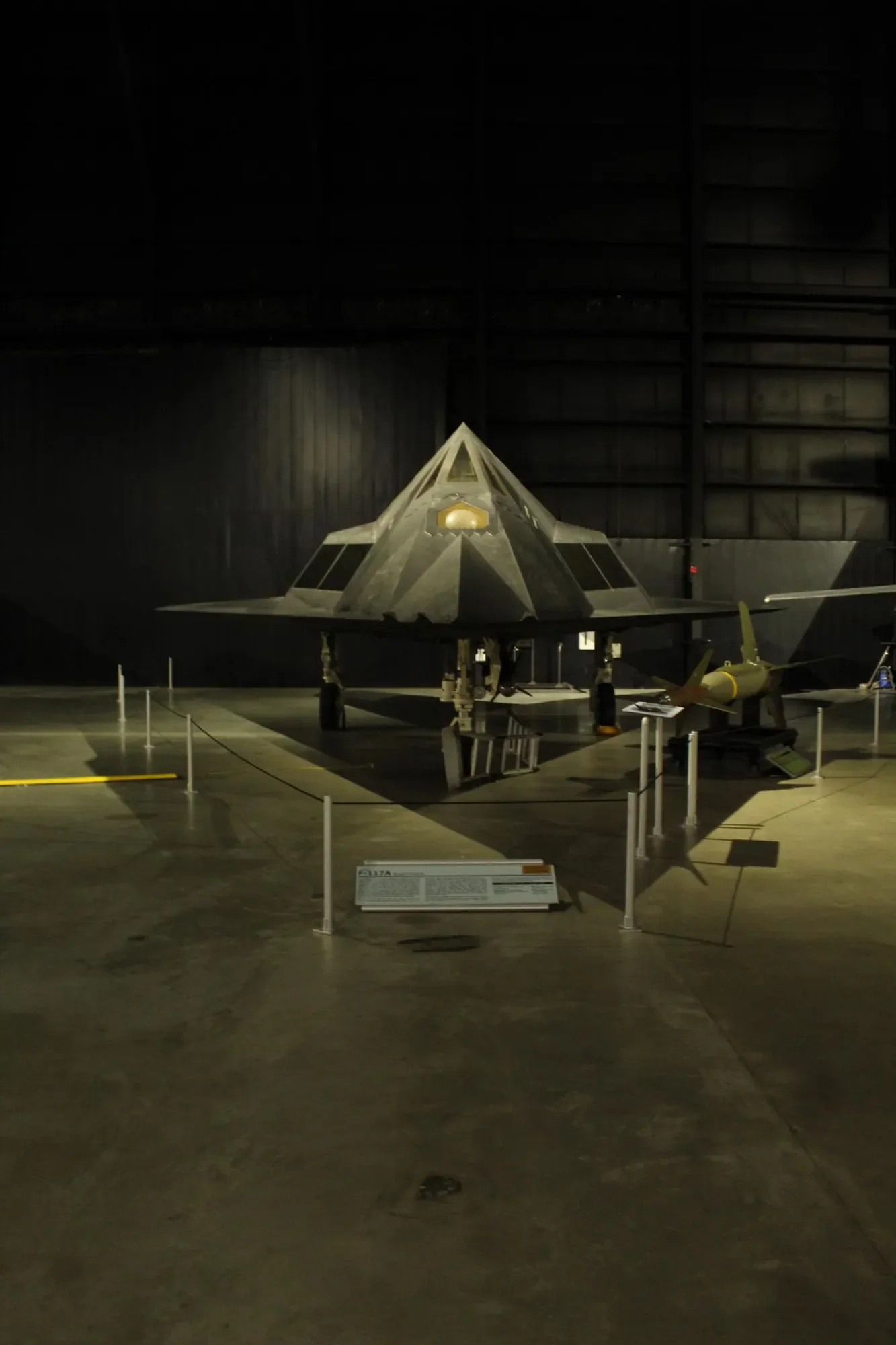 F-117 aircraft photographed head-on in a museum gallery