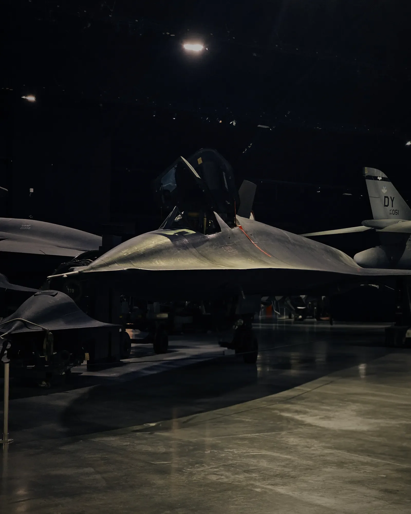SR-71 aircraft viewed from the front-right side in a dark gallery