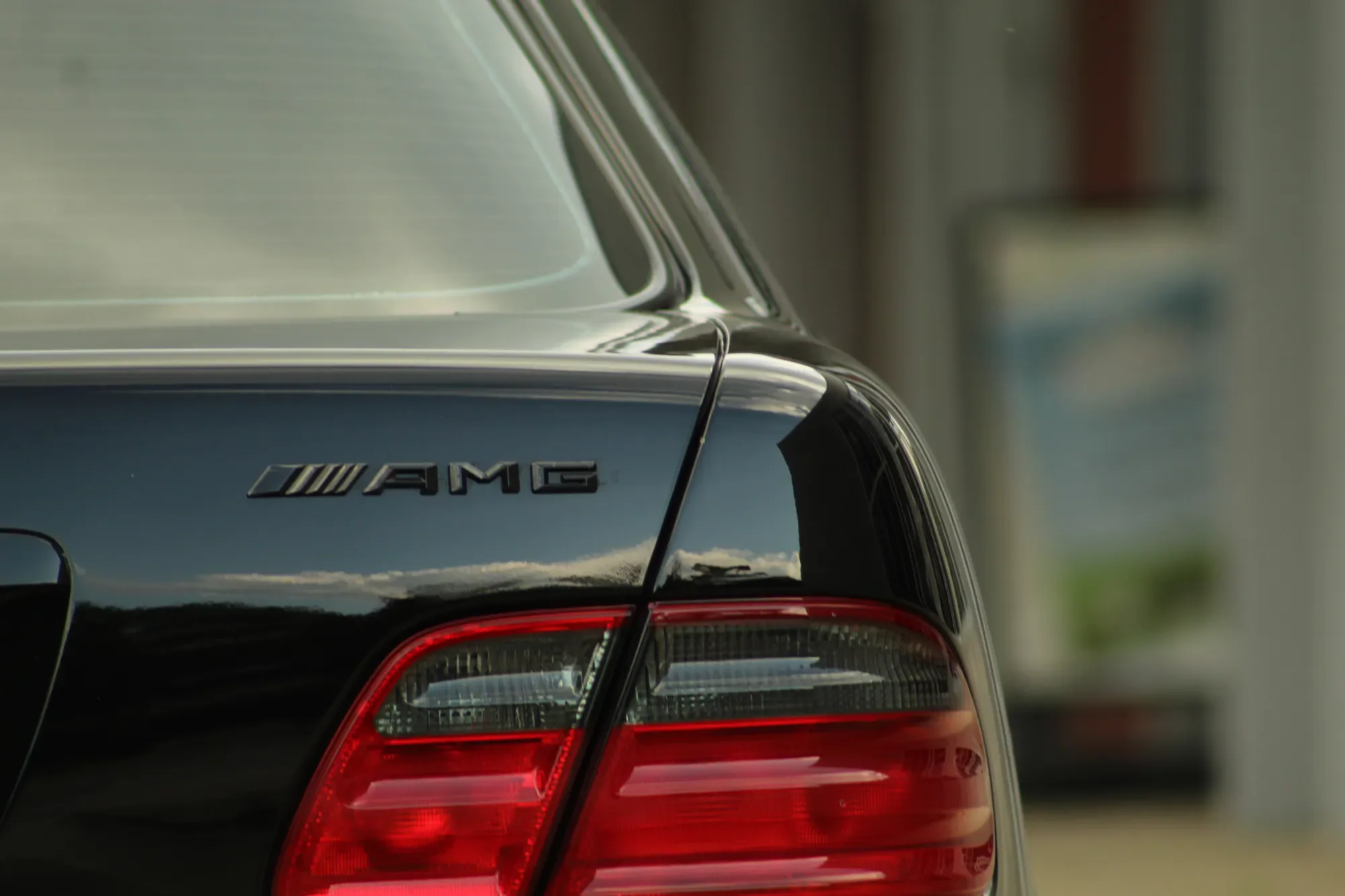 AMG badge and taillight detail on a black Mercedes-Benz E55
