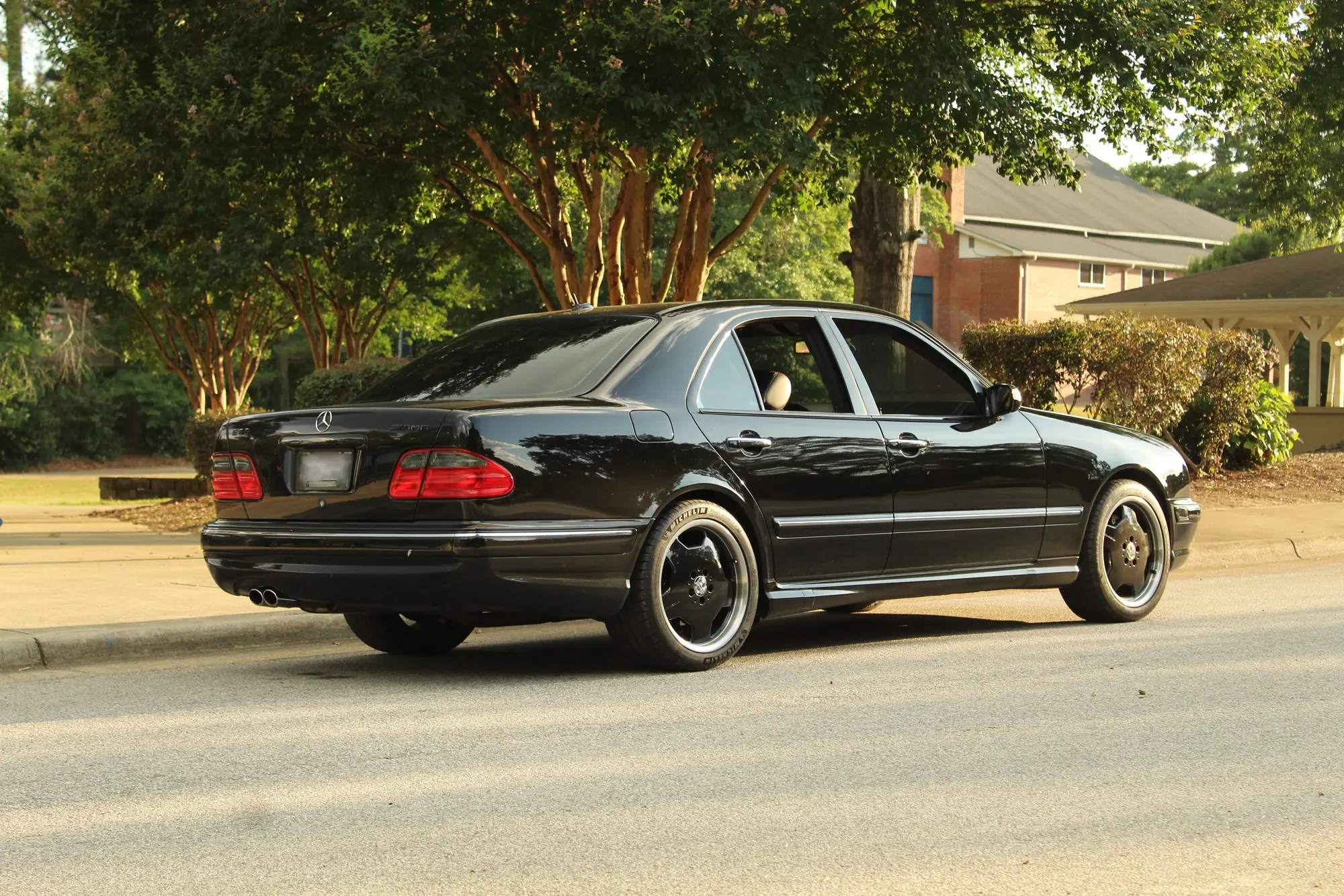 Black Mercedes-Benz AMG E55 photographed in motion