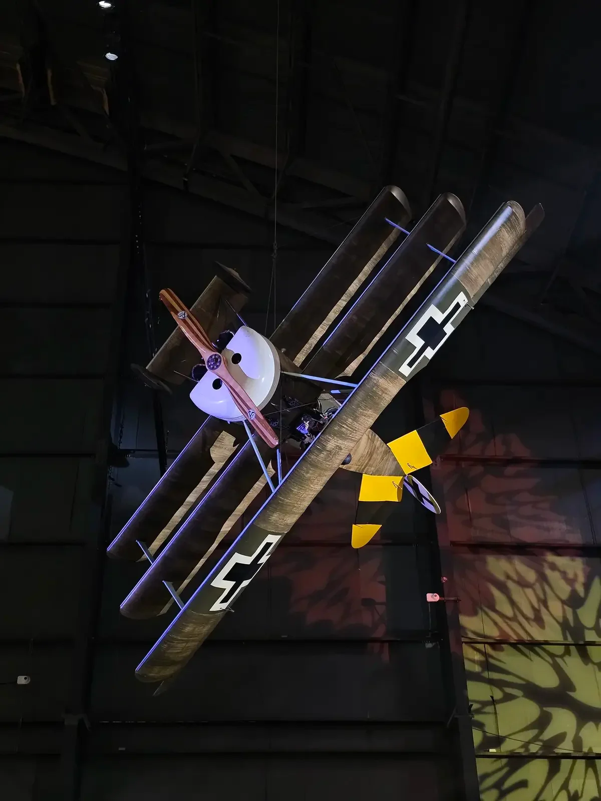 Historic biplane suspended inside an aviation museum
