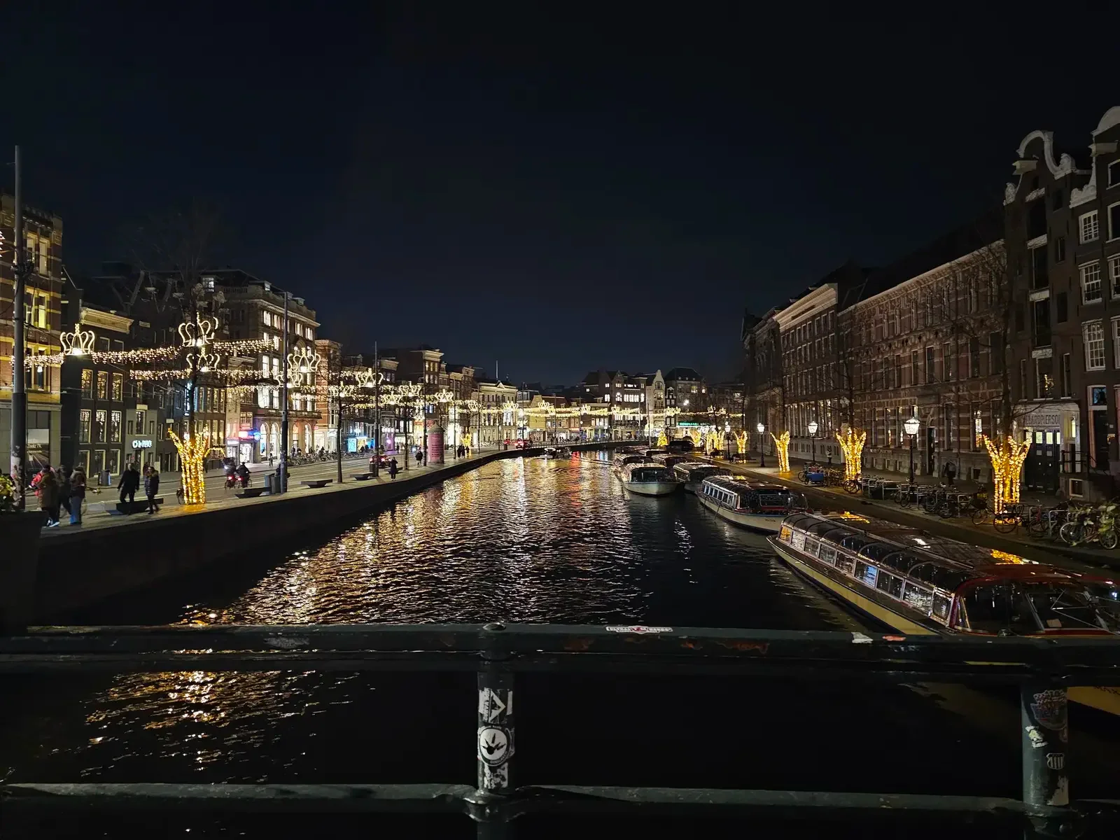 Canal houses and city lights reflected on the water at night