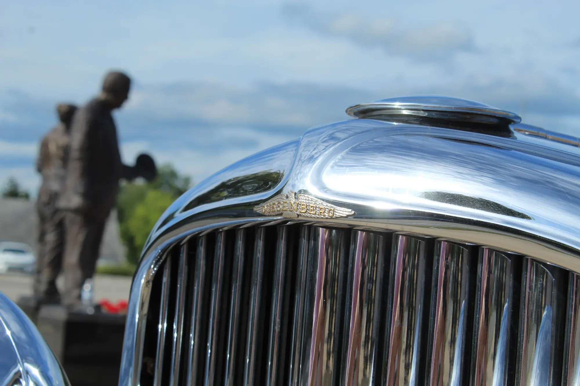 Chrome grille and hood detail of a blue Duesenberg Model J Murphy Clear Vision Sedan