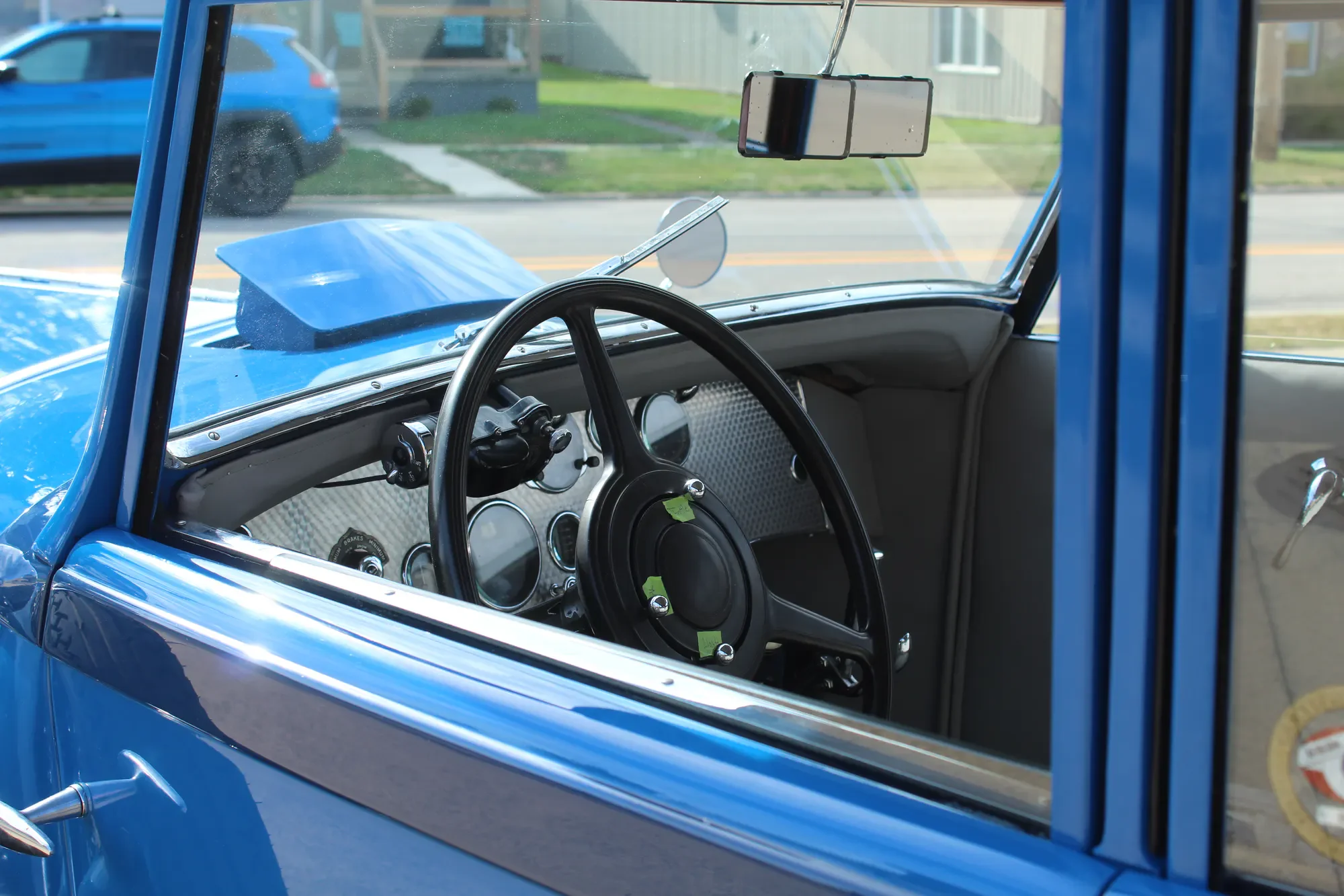 Steering wheel and cockpit of the blue Duesenberg Model J Murphy Clear Vision Sedan