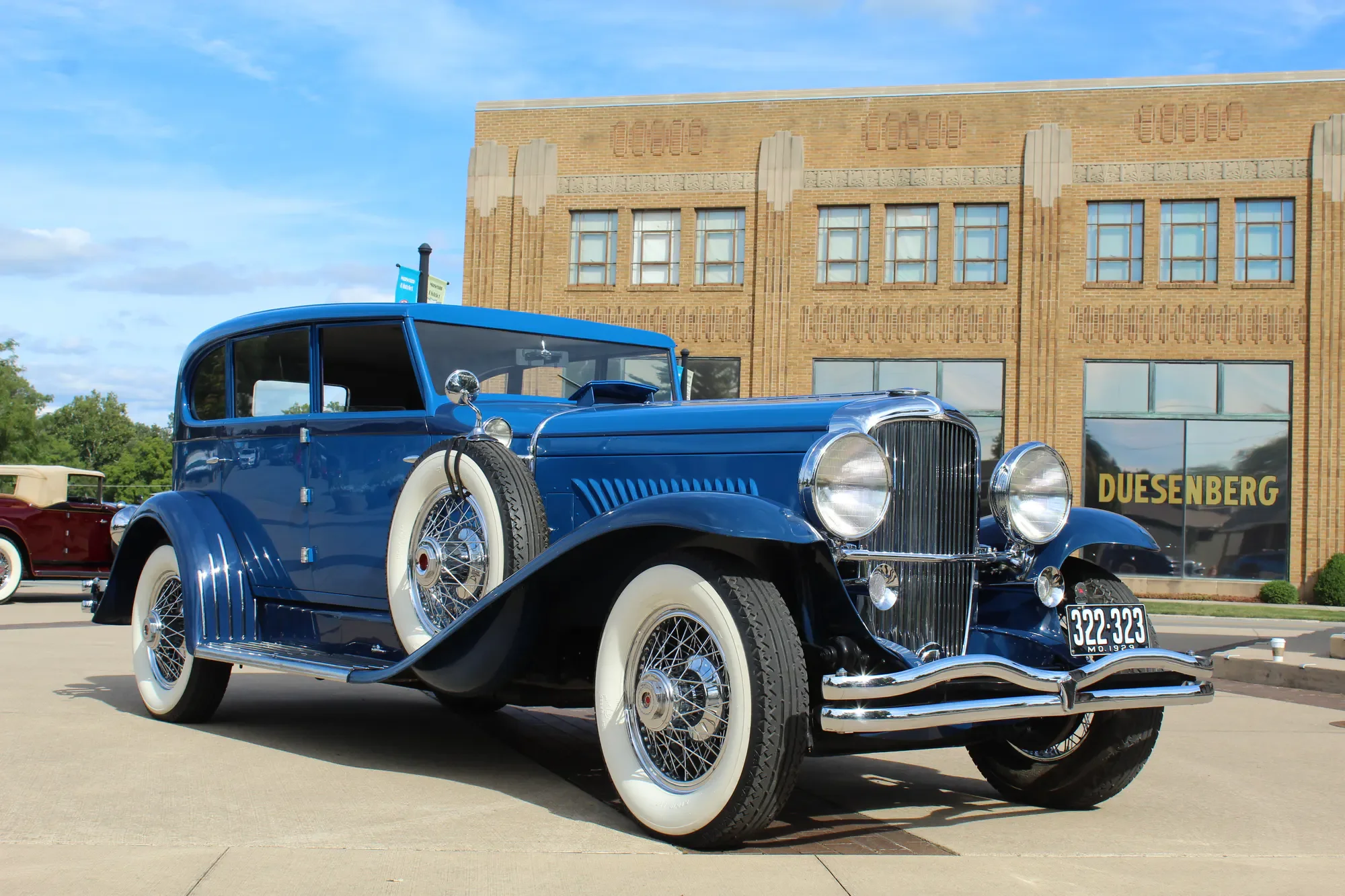 Blue Duesenberg photographed in profile outside the Auburn Cord Duesenberg Museum